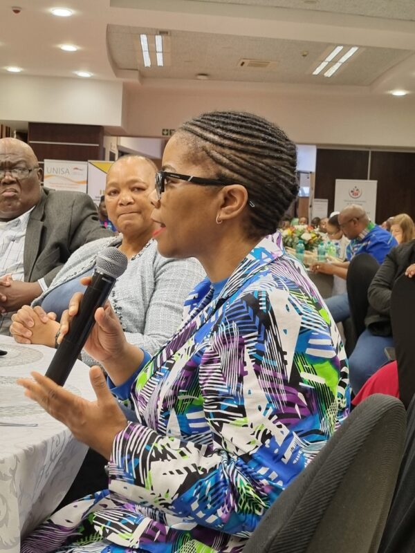 Prof Puleng Lenka Bula speaks whilst seated at a table